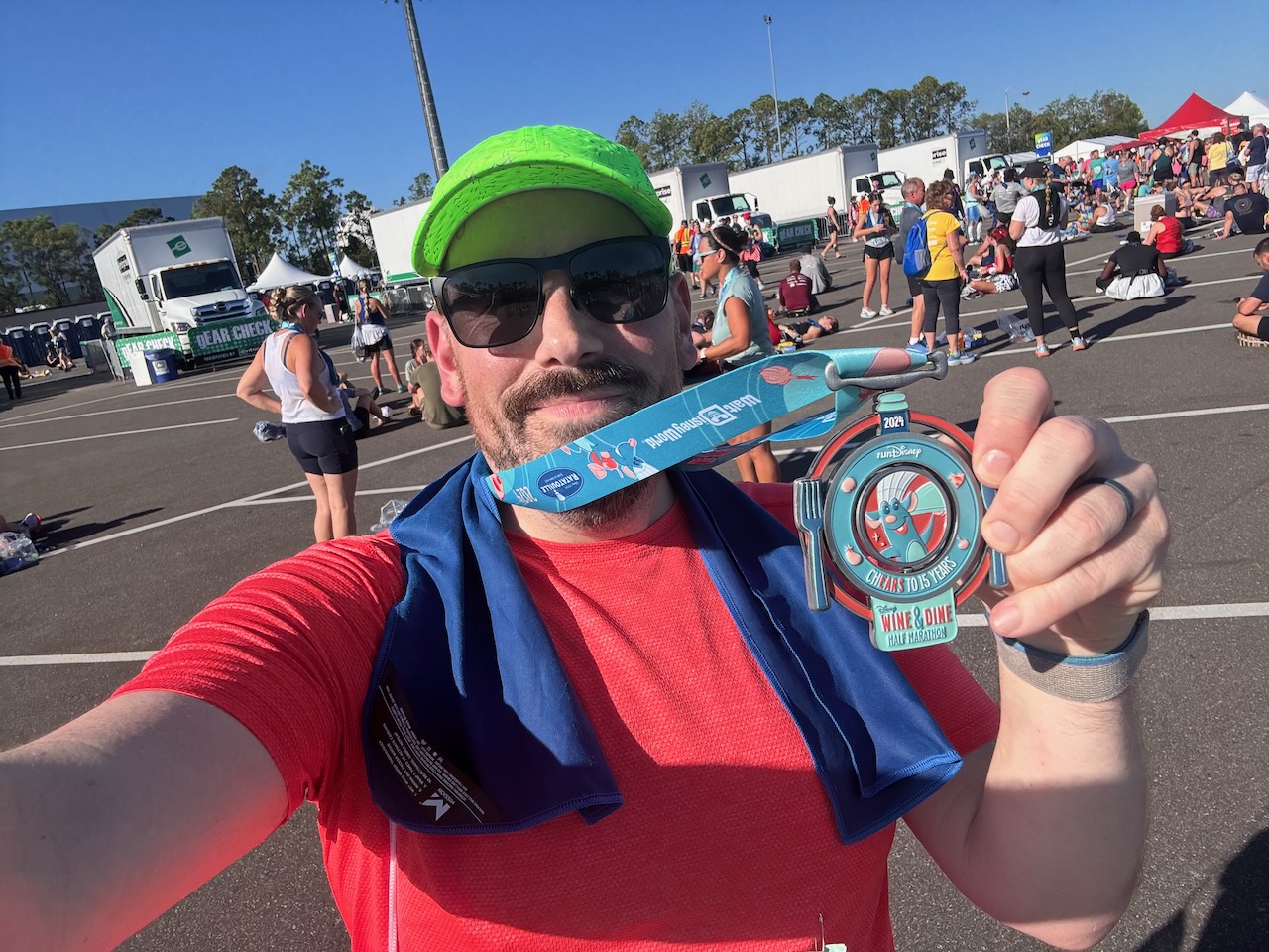 Will posing with his finisher's medal from the 2024 Wine & Dine Half Marathon